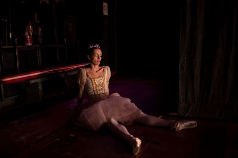 A ballet dancer rests during a rehearsal of 