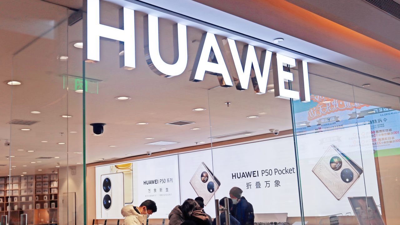 A customer experiences the P50 Pocket, the first 5G foldable mobile phone, at a Huawei store in Shanghai, China, Jan. 1, 2022.