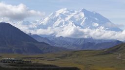 FILE - In this Aug. 26, 2016, file photo sightseeing buses and tourists are seen at a pullout popular for taking in views of North America's tallest peak, Denali, in Denali National Park and Preserve, Alaska. No permits have been issued to climb Denali or Mount Foraker this year. The climbing season in the national park about 180 miles (290 kilometers) north of Anchorage usually begins in late April and ends in mid-July. Refunds will be issued to those who have started the registration process. (AP Photo/Becky Bohrer, File)
