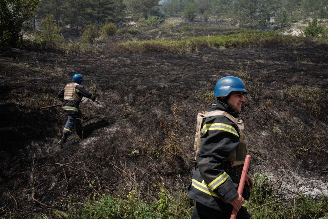 Ukrainian attempt to extinguish a fire caused by shelling in Sydorove, in eastern Ukraine, on May 17, 2022.