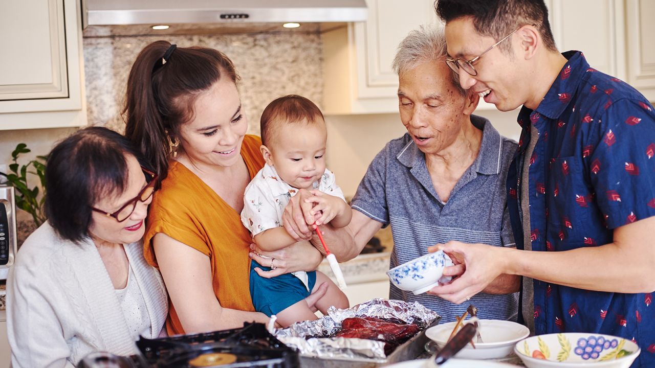 Three generations of the Lau family gather in their kitchen. Left to right: Jenny, Kat, Cameron, Chung Sun ("Daddy Lau") and Randy.