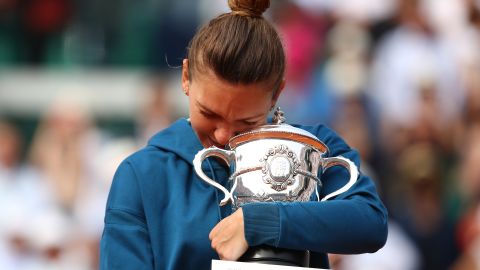 Simona Halep kisses the trophy as she celebrates winning after the women's singles final against Sloane Stephens in the French Open final on June 9, 2018 in Paris, France.