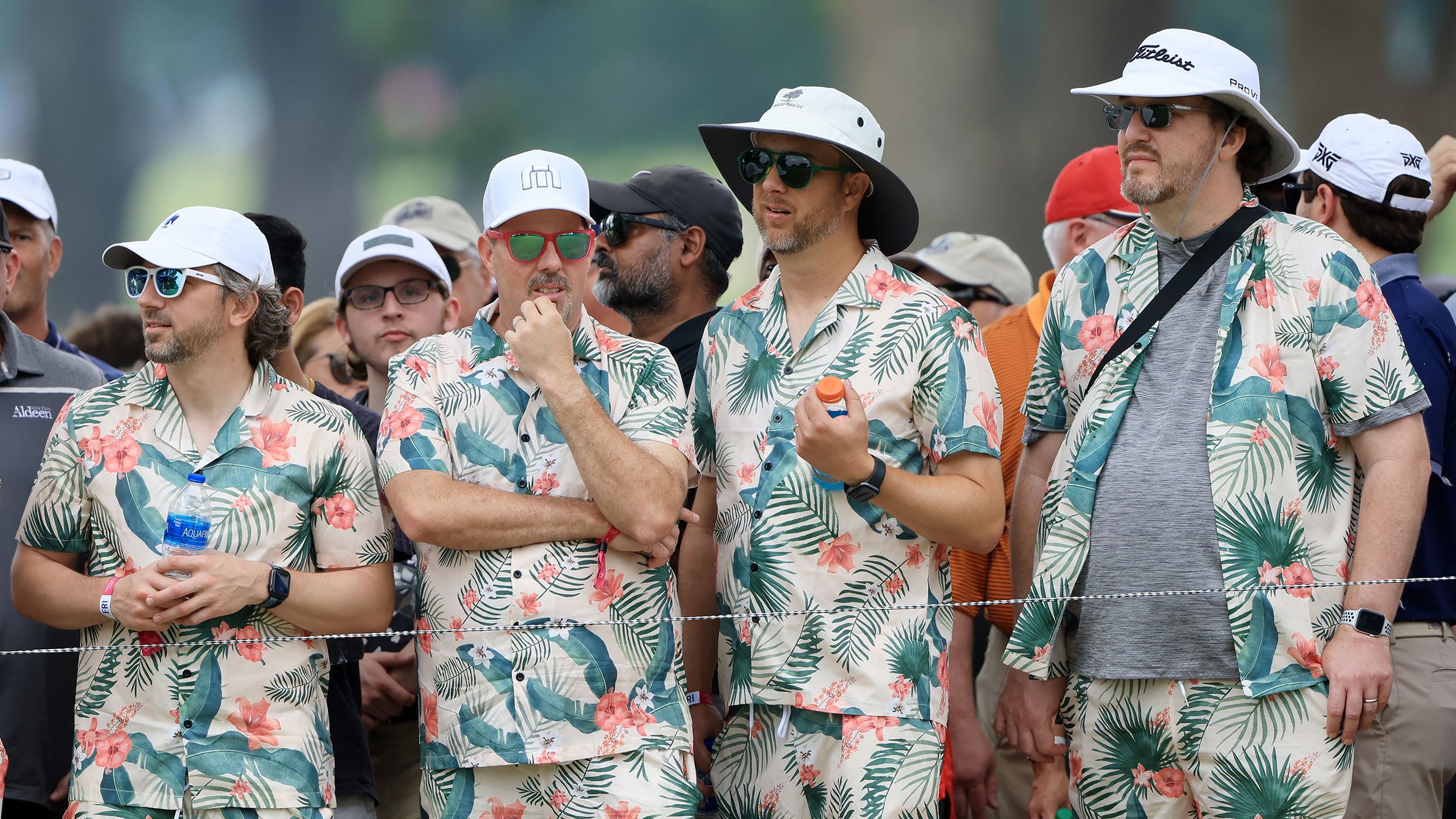 Fans dressed in matching Hawaiian shirts and shorts watch the action during the second round.
