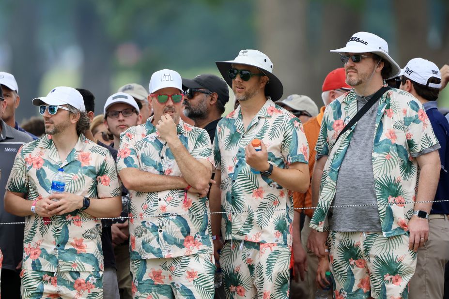 Fans dressed in matching Hawaiian shirts and shorts watch the action during the second round.