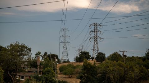 Pictured are power lines in California in August 2020, when rolling blackouts were designed to save the power grid from a heat wave. It will be hot again this summer.