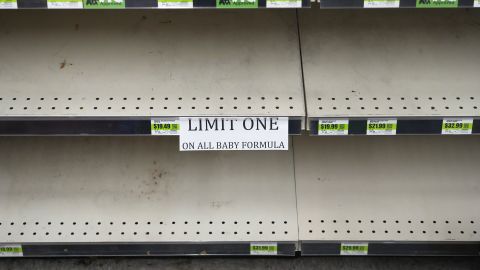 A sign in front of empty shelves notifies customers that they are allowed only one container of baby formula at a store in Utah this month. 