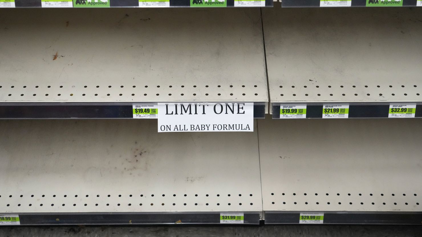 A sign in front of empty shelves notifies customers that they are allowed only one container of baby formula at a store in Utah this month. 