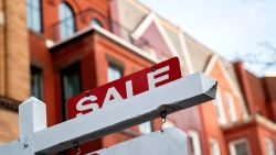 A For Sale sign is displayed in front of a house in Washington, DC, on March 14, 2022. 