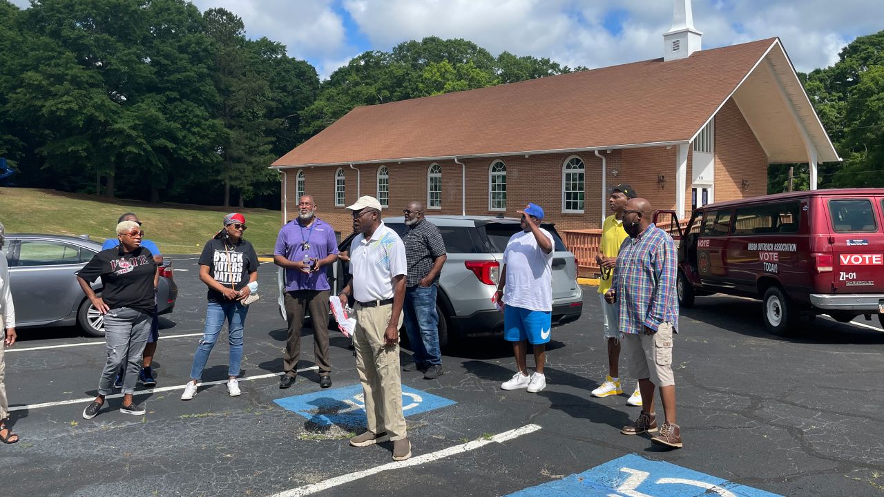 Elbert Solomon, center, co-chair of the Spalding County Voting Project, leads the group in singing "We Shall Overcome" before heading to the polls in Griffin, Georgia, on Saturday, May 14.