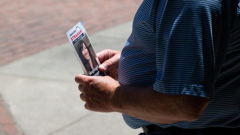 A person holds a campaign flyer for Strahan in Rome on May 12, 2022.