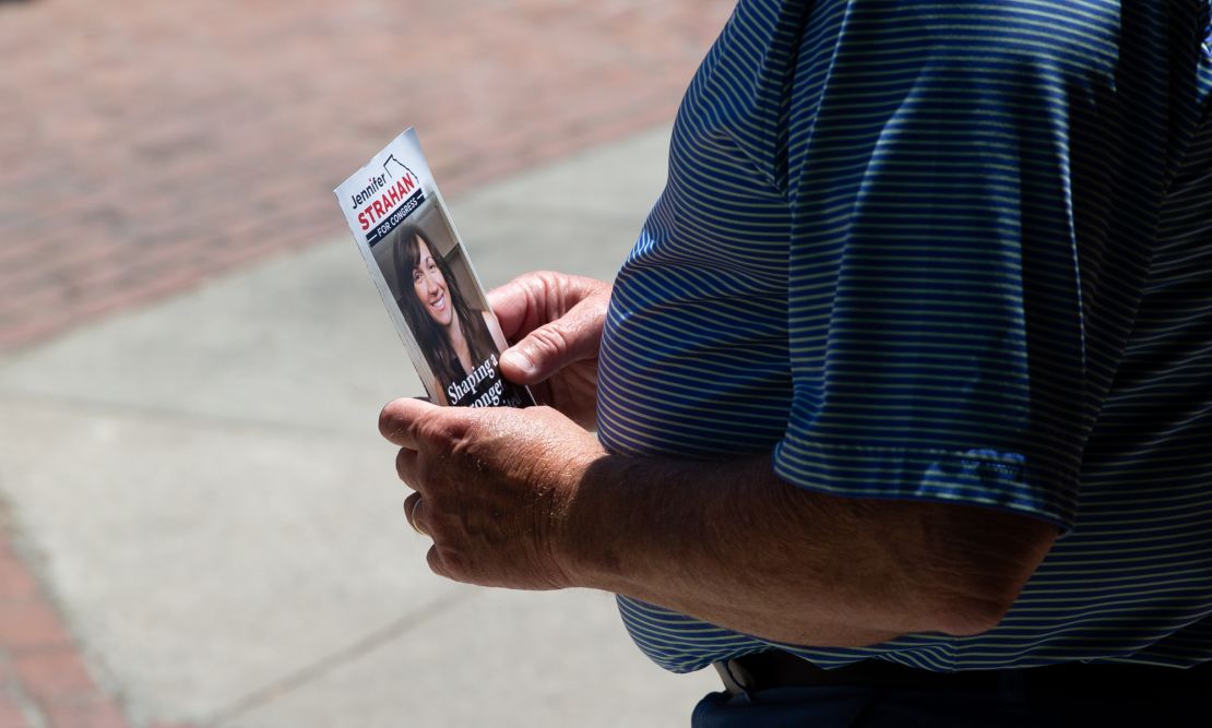 A person holds a campaign flyer for Strahan in Rome on May 12, 2022.