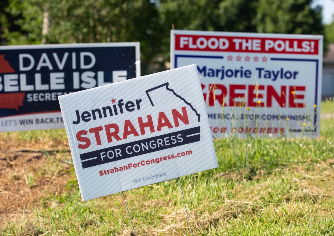 Campaign signs for Strahan, center, and Greene, right, are seen just outside of Rome in Silver Creek, Georgia, on May 12, 2022.
