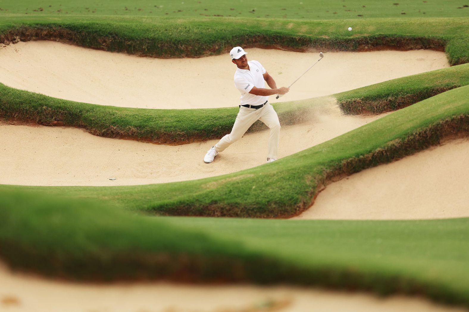 Xander Schauffele plays a shot from a bunker on the fifth hole during the second round.