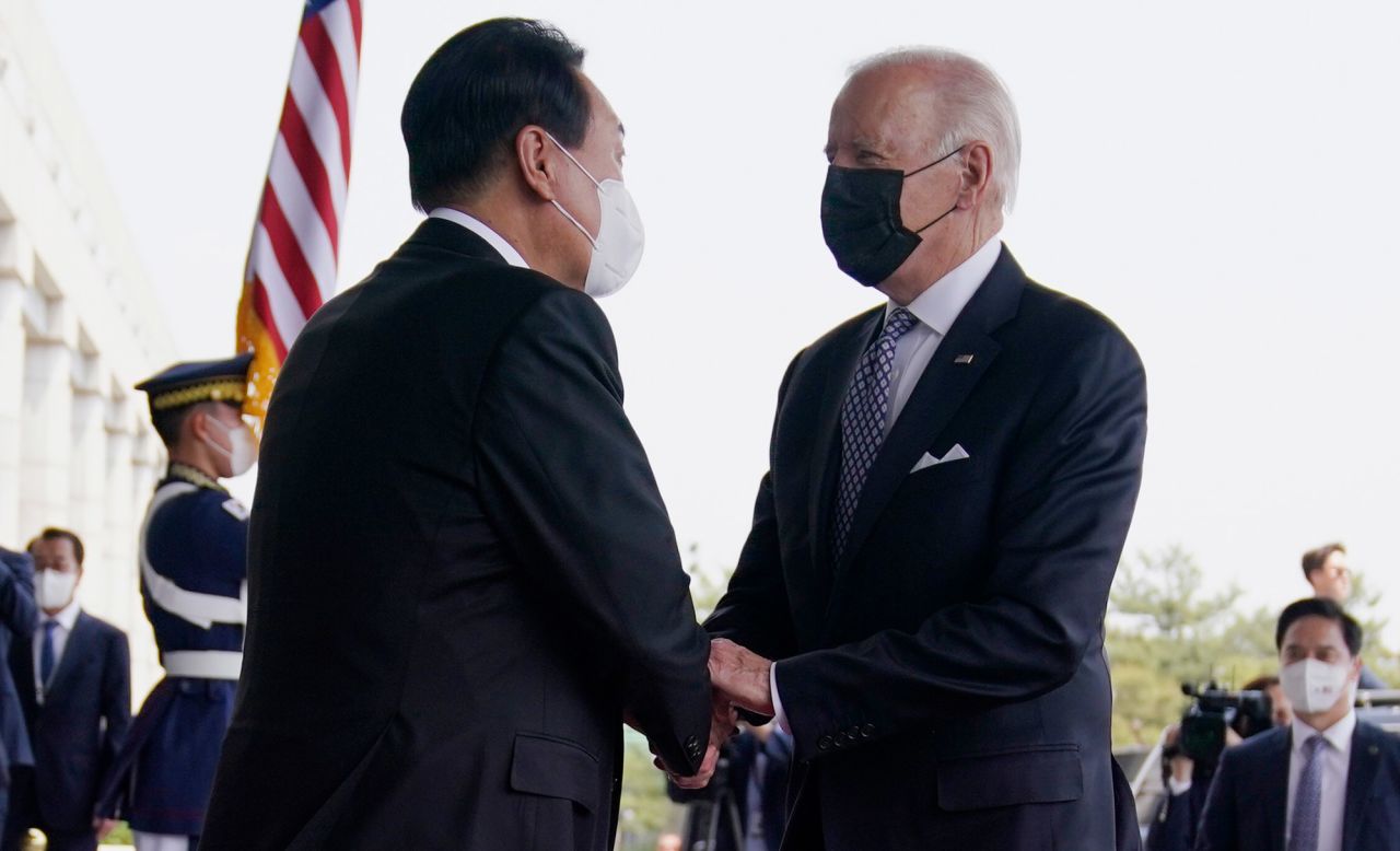 Yoon greets Biden prior to their bilateral meeting at the People's House in Seoul.