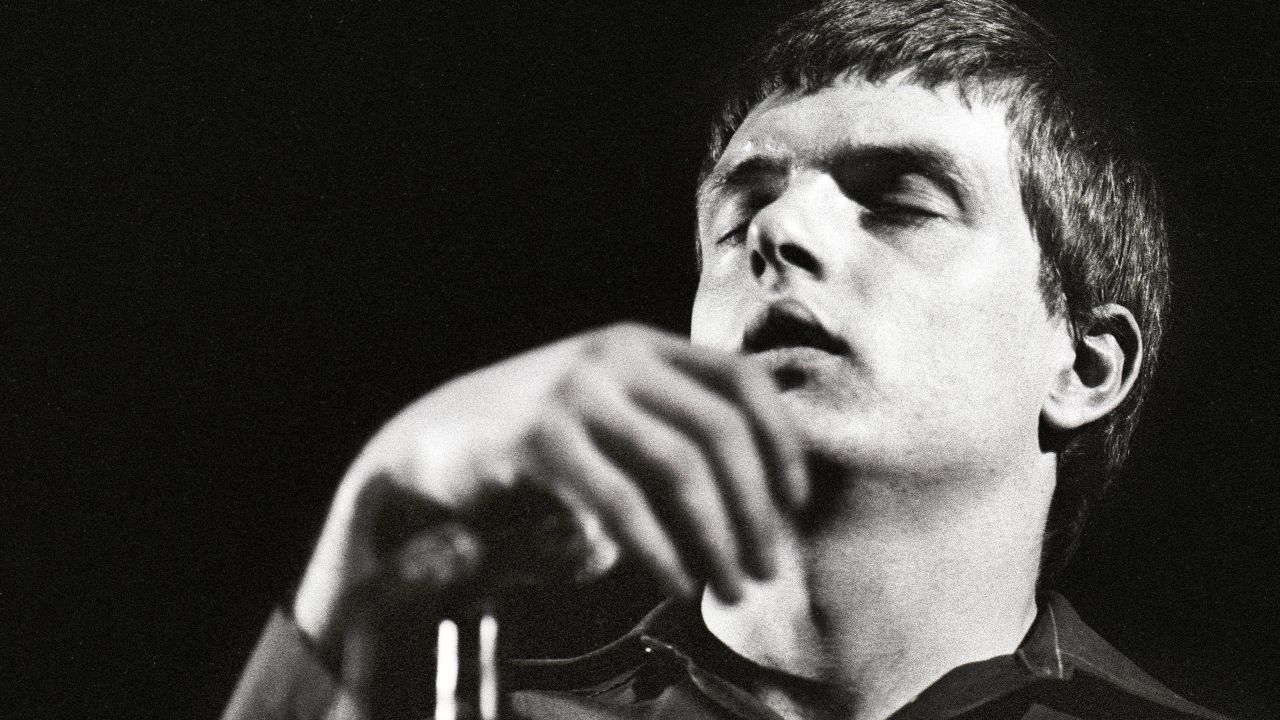 Joy Division frontman Ian Curtis performing onstage before his death in 1980.