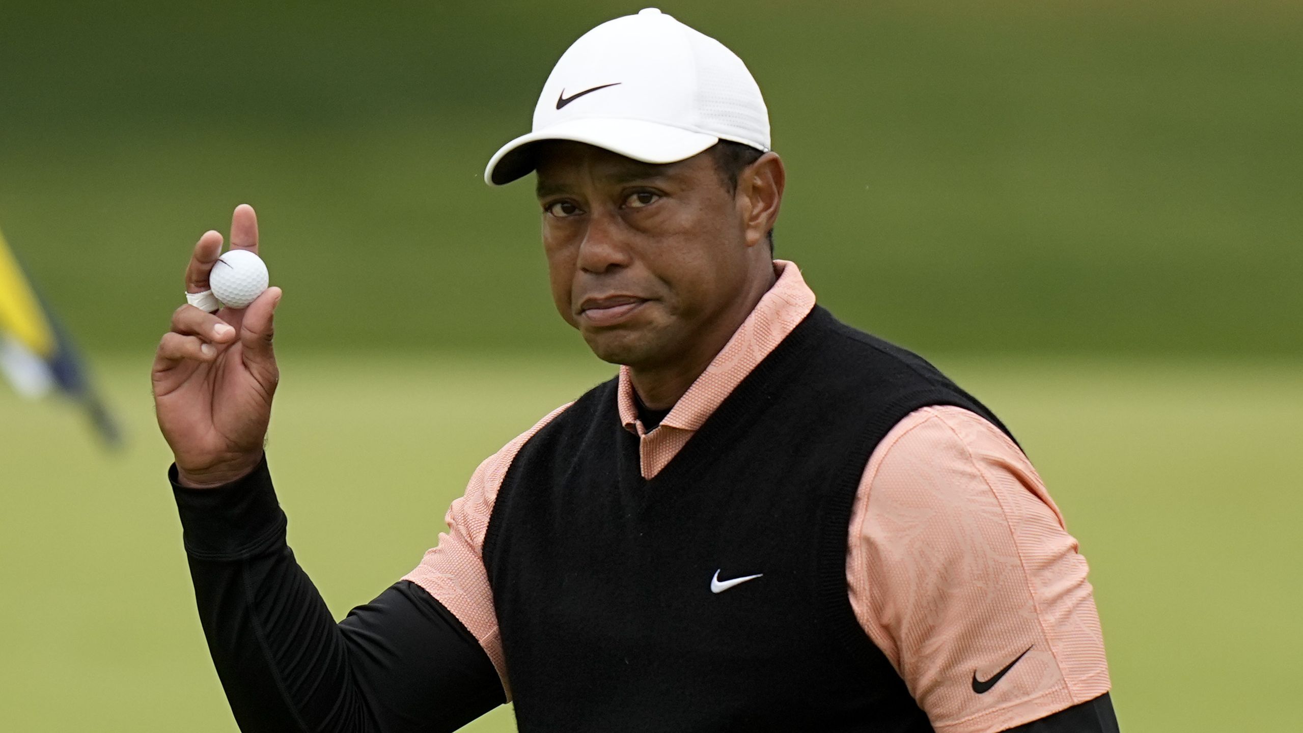 Tiger Woods waves after his third round on the 18th hole on Saturday, May 21, in Tulsa, Oklahoma. Woods withdrew from the competition after struggling in his third round. 