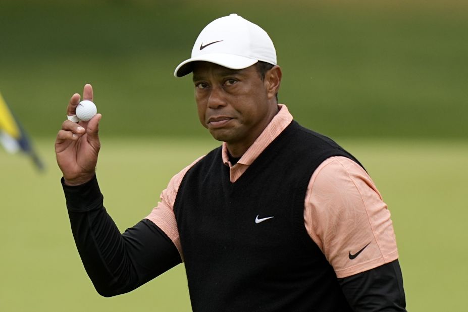 Tiger Woods waves after his third round on the 18th hole on Saturday, May 21, in Tulsa, Oklahoma. Woods withdrew from the competition after struggling in his third round. 