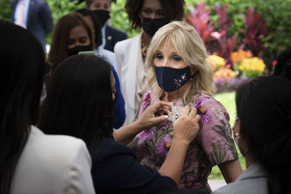 First lady Jill Biden receives a pin from a woman at an event for women entrepreneurs at the U.S. Chief of Mission Residence in San José, Costa Rica, Saturday, May 21, 2022. The women in attendance have participated in U.S. State Department-sponsored programs focused on entrepreneurship. 