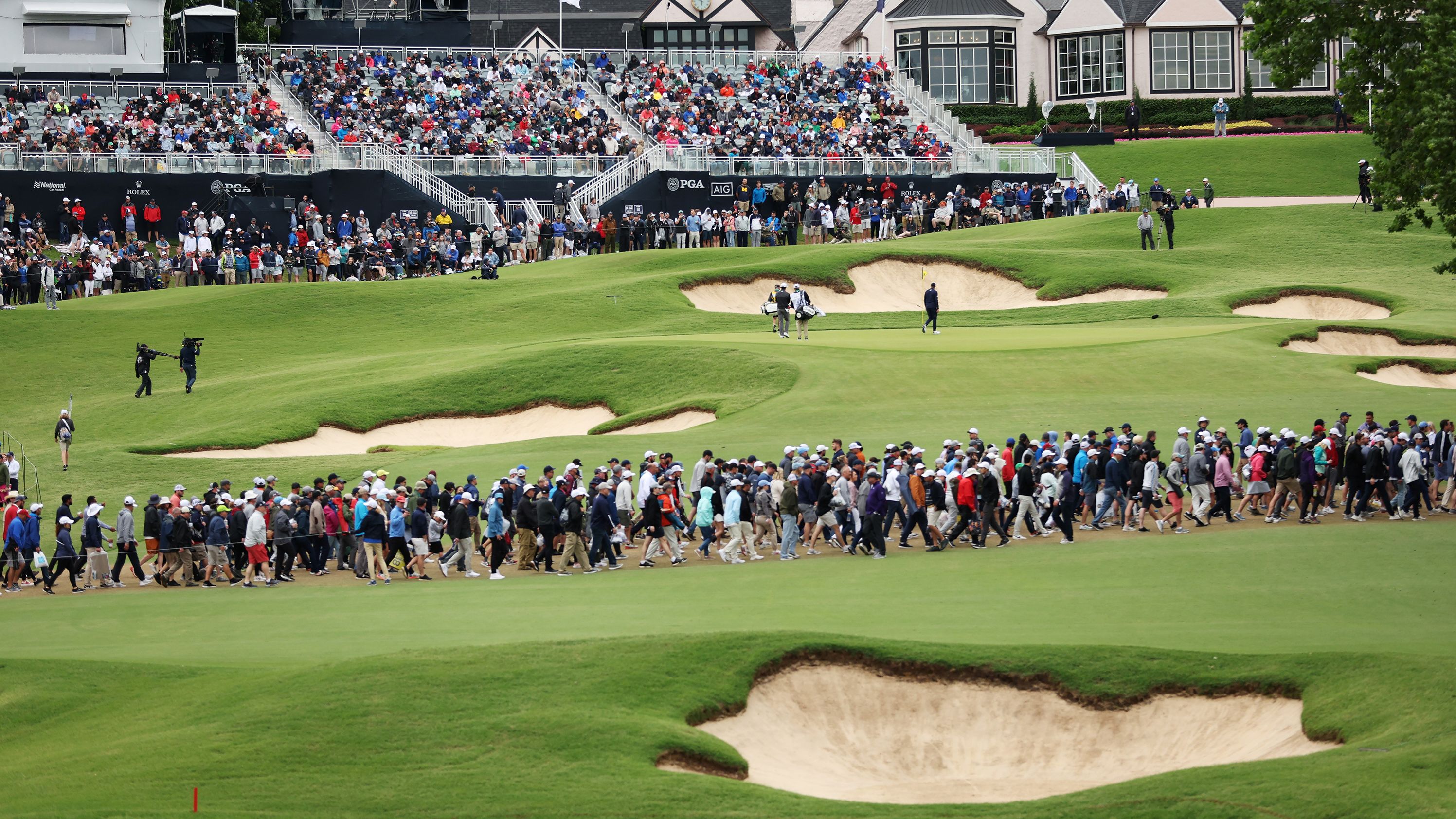 Matt Fitzpatrick and Davis Riley walk on the 18th green during the third round.