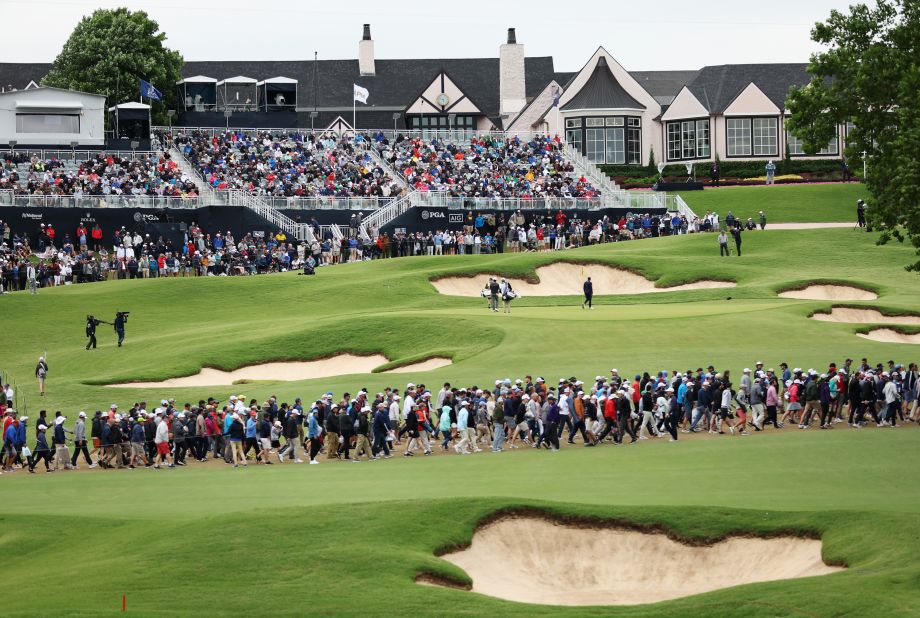 Matt Fitzpatrick and Davis Riley walk on the 18th green during the third round.