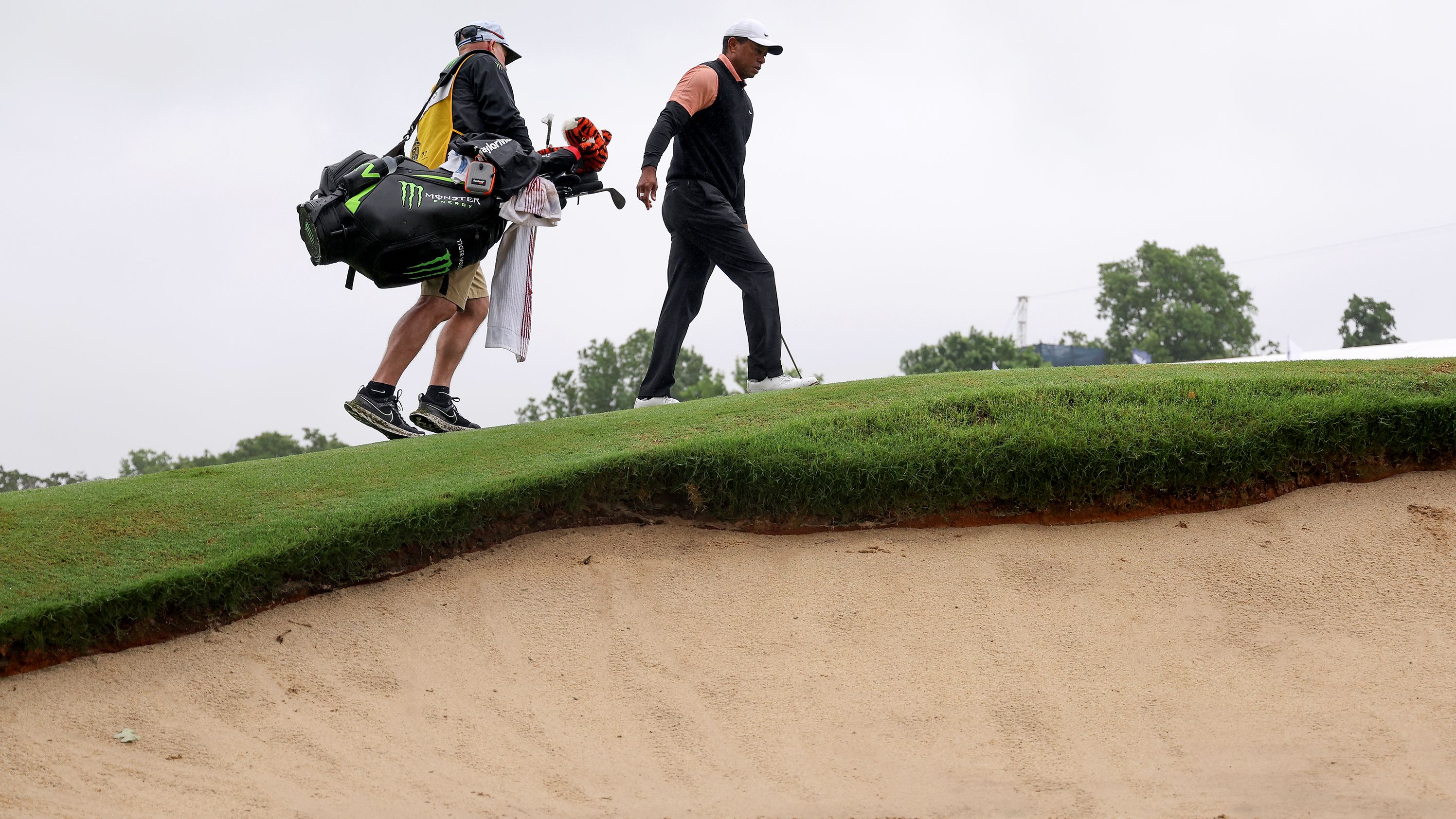 Tiger Woods and his caddy walk on the ninth green during the third round.