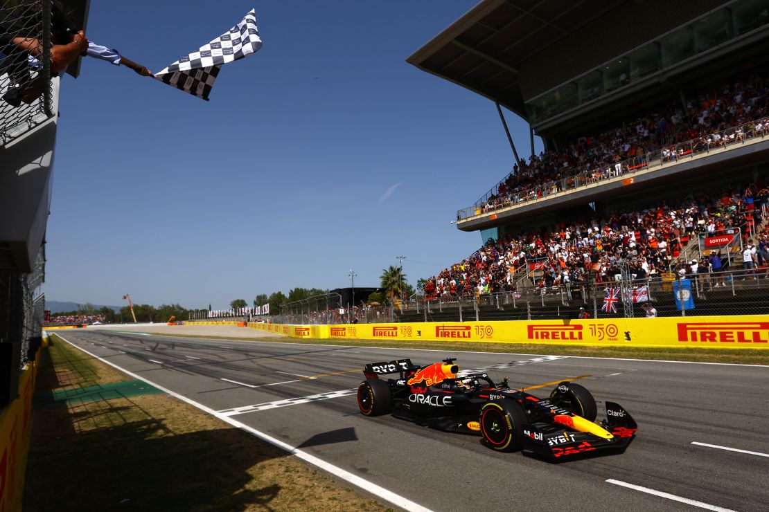 The chequered flag waves Verstappen home.