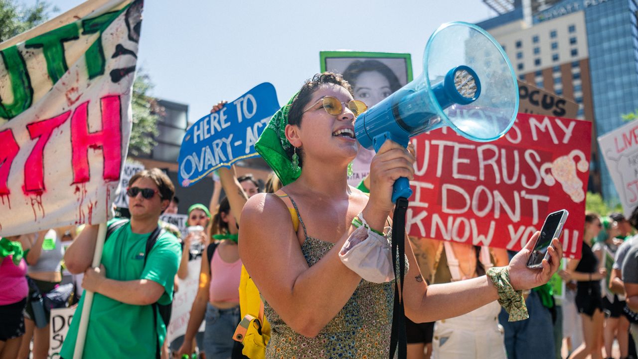 Abortion rights activists and supporters march outside of the Austin Convention Center where the American Freedom Tour with former President Donald Trump was held on May 14, 2022 in Austin, Texas.