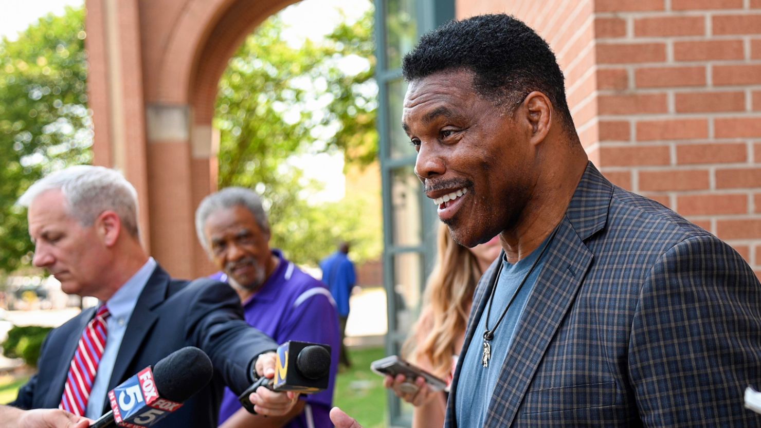 US Senate candidate Herschel Walker speaks with the media after a campaign rally at the Georgia Sports Hall of Fame in Macon, Ga., Wednesday, May 18, 2022. 