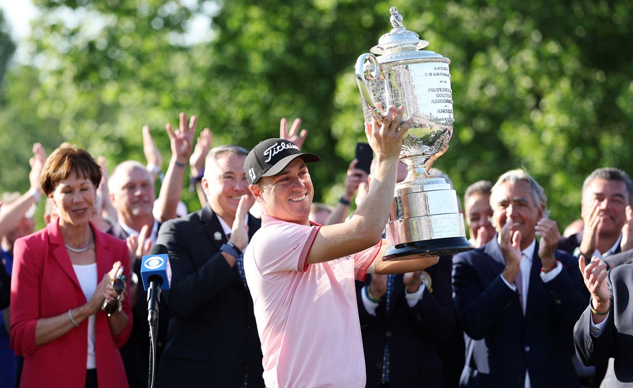Justin Thomas celebrates with the Wanamaker Trophy after putting in to win on the 18th green, the third playoff hole during the final round of the 2022 PGA Championship on Sunday, May 22, 2022, in Tulsa, Oklahoma.