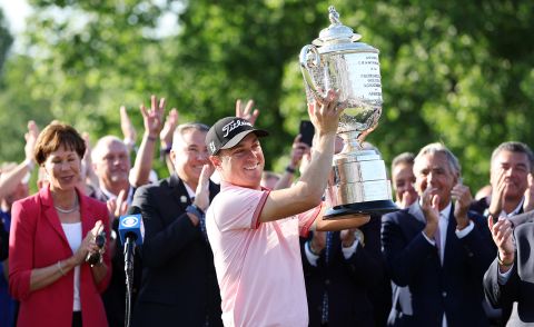Justin Thomas celebrates with the Wanamaker Trophy after putting in to win on the 18th green, the third playoff hole during the final round of the 2022 PGA Championship on Sunday, May 22, 2022, in Tulsa, Oklahoma.