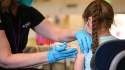 A nurse administers a pediatric dose of the Covid-19 vaccine to a girl at a L.A. Care Health Plan vaccination clinic at Los Angeles Mission College in the Sylmar neighborhood in Los Angeles, California, January 19, 2022. 
