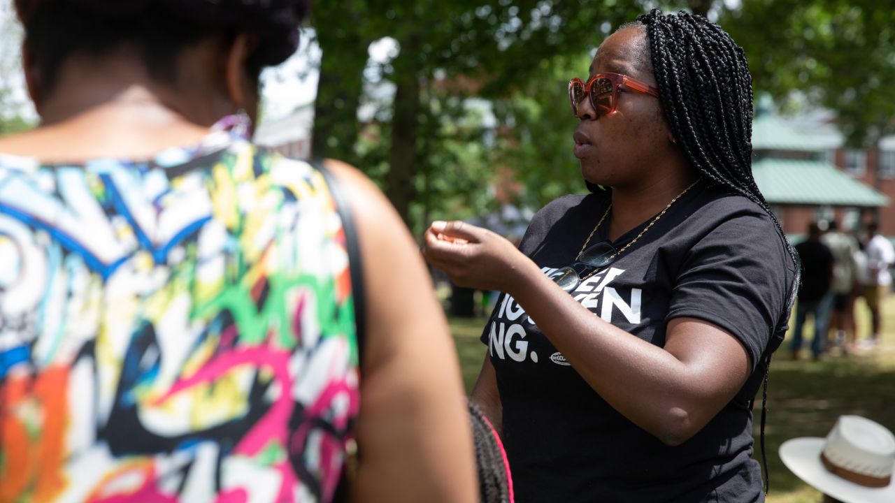 Maria Banjo, Nguyen's campaign manager, speaks with people an event in Hapeville, Georgia.