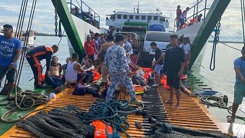 The Philippine coast guard checks rescued passengers at the port of Real in Quezon province on May 23.