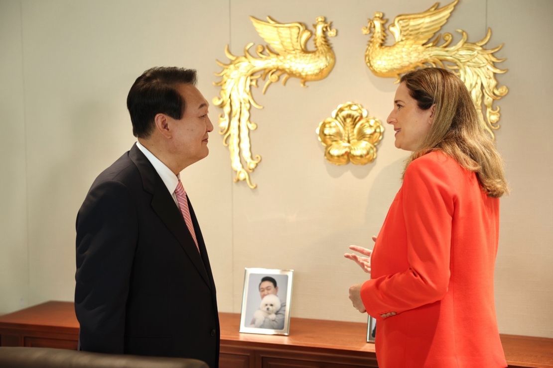 Yoon speaks with CNN's international correspondent Paula Hancocks on May 23 in the presidential office, decorated with a framed photo of Yoon with one of his family's many pets, which include four dogs and three cats.