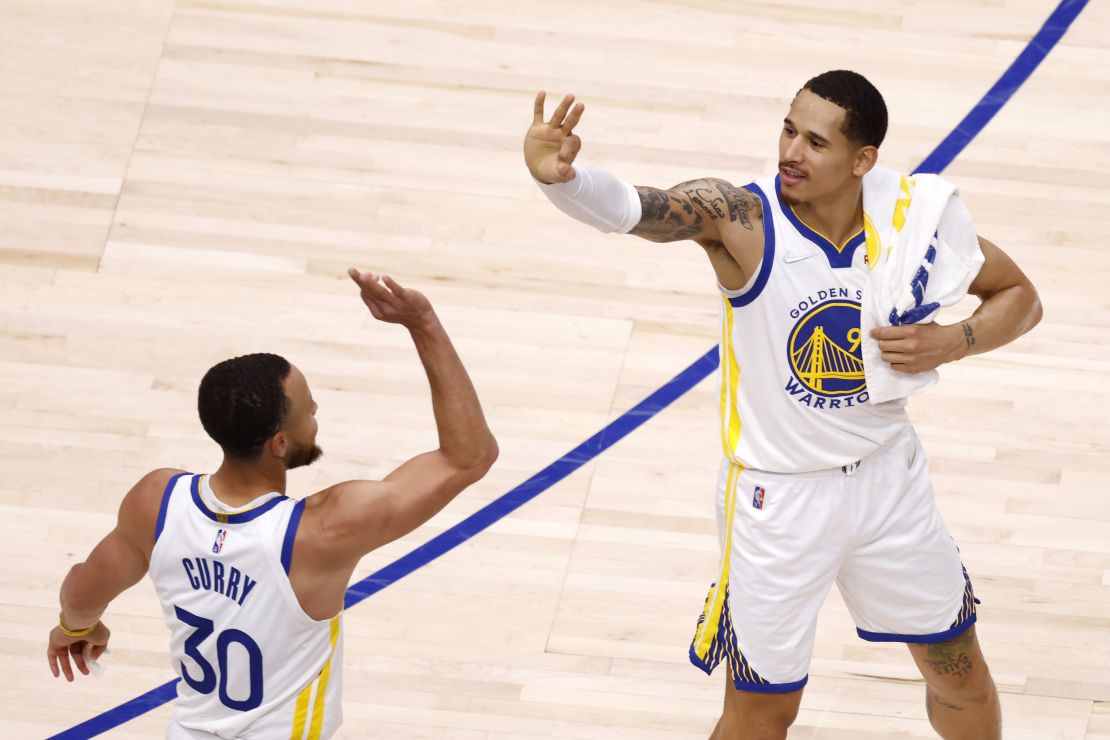 Stephen Curry and Juan Toscano-Anderson celebrate during the win against the Dallas Mavericks.