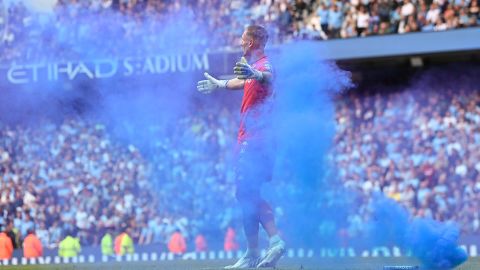 Olsen reacts after a flare is thrown onto the pitch during the Premier League match between Manchester City and Aston Villa.