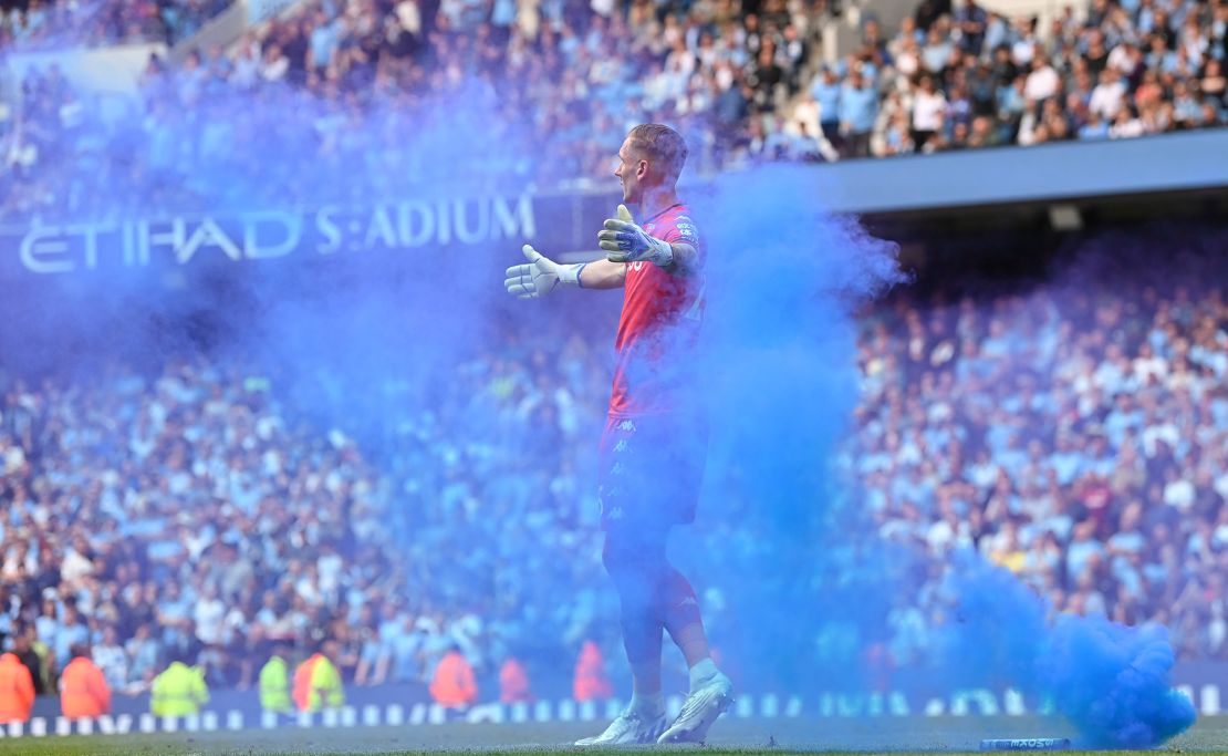 Olsen reacts after a flare is thrown onto the pitch during the Premier League match between Manchester City and Aston Villa.