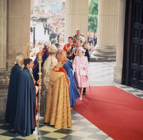 The Queen is greeted at St. Paul's Cathedral on June 7, 1977, for a thanksgiving service to mark her 25 years on the throne. She is followed by her husband, Prince Philip, and eldest child, Prince Charles.