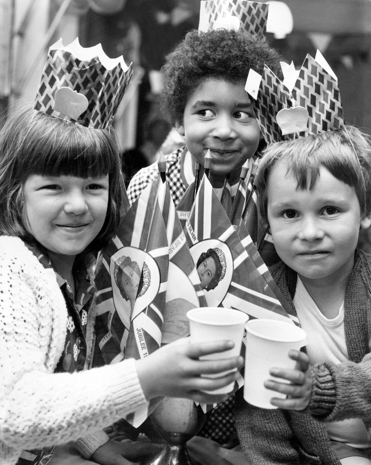 Children toast to the sovereign at a street party in Liverpool in 1977 to mark the Queen's 25-year reign.