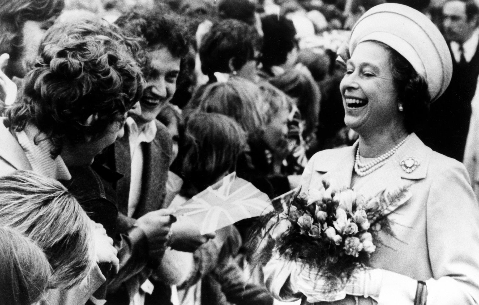 The Queen enjoys a laugh with two young well-wishers at St. Katherine's Dock, London during the final Silver Jubilee event -- a trip down the Thames river on June 9, 1977.