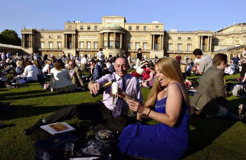 Craig Metcalf and Jayne Wood, both from Brighouse, Yorkshire, join thousands of others in the grounds of Buckingham Palace in London for the Prom at the Palace, a classical concert, on the first evening of the Golden Jubilee celebratory weekend in 2002.
