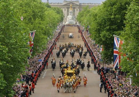 Huge crowds flood both sides of the Mall in central London to see the Queen and the Duke of Edinburgh travel to St. Paul's Cathedral for a service of thanksgiving to celebrate the Golden Jubilee, on June 4, 2002.