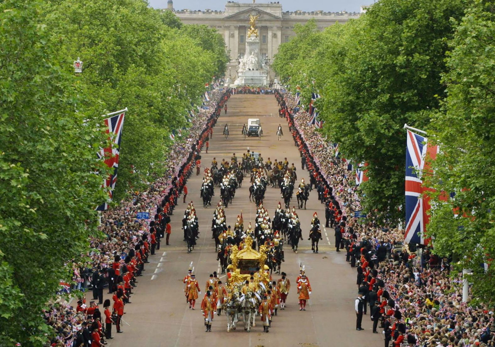 Huge crowds flood both sides of the Mall in central London to see the Queen and the Duke of Edinburgh travel to St. Paul's Cathedral for a service of thanksgiving to celebrate the Golden Jubilee, on June 4, 2002.