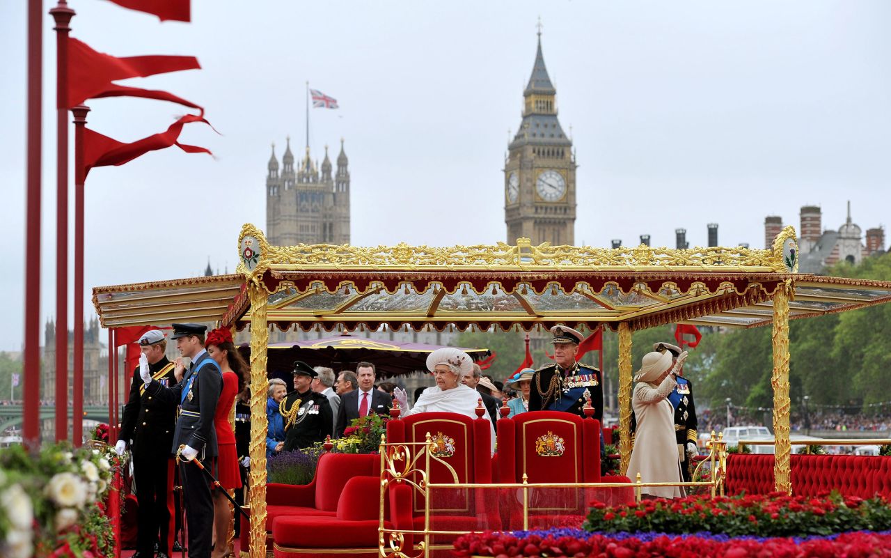 The Queen and Duke of Edinburgh on board the "Spirit of Chartwell" royal barge during the Diamond Jubilee Pageant on the Thames. The couple are accompanied by family members including the Duke and Duchess of Cambridge, the Duke of Sussex, the Prince of Wales and the Duchess of Cornwall.