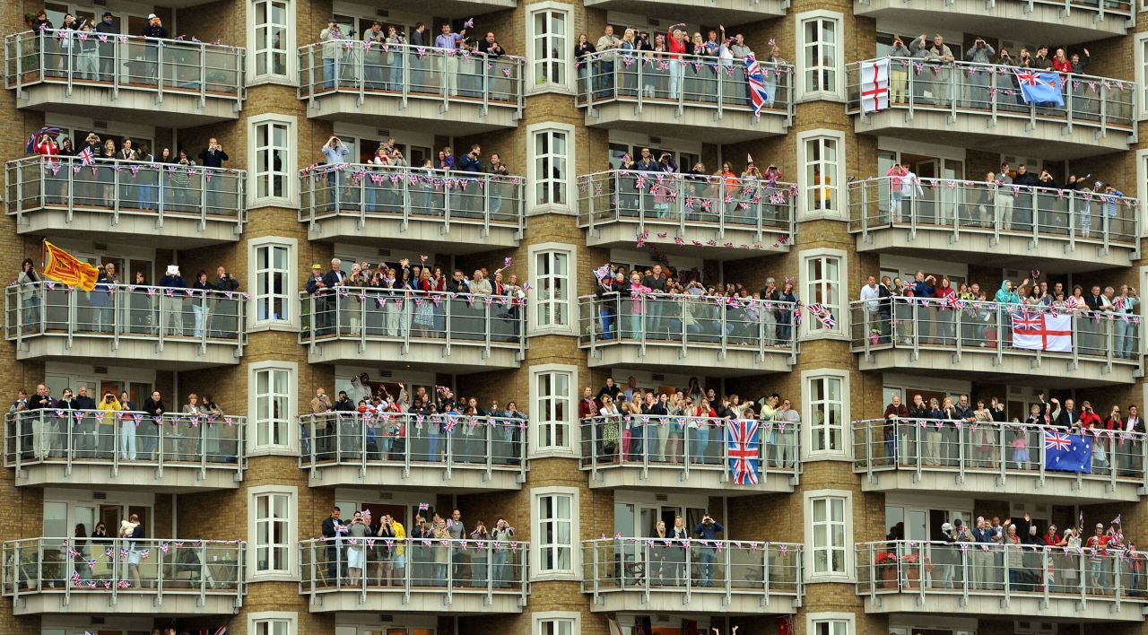 Balconies of apartment blocks along the Thames are packed with royal-watchers.