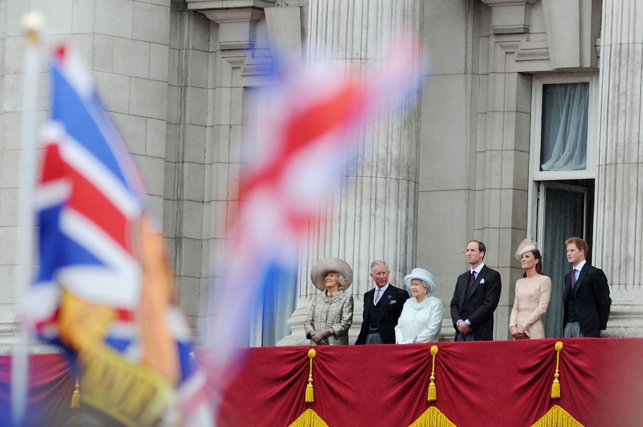 The Windsors gather on the Buckingham Palace balcony without Prince Philip, who was hospitalized for an infection a day earlier.