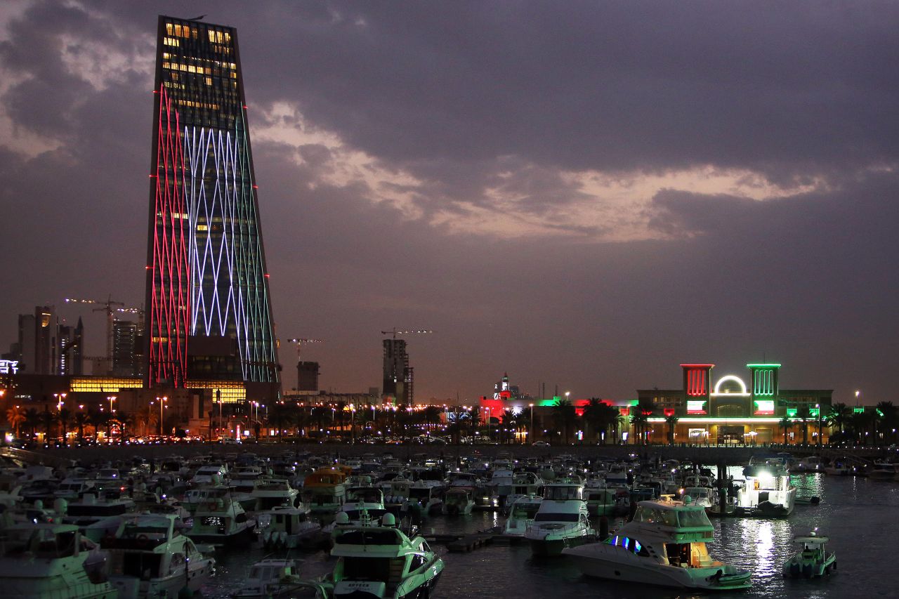 Kuwaiti buildings are illuminated in the colors of the national flag on February 20, 2021. Kuwait is now "moderate" risk for Covid-19.