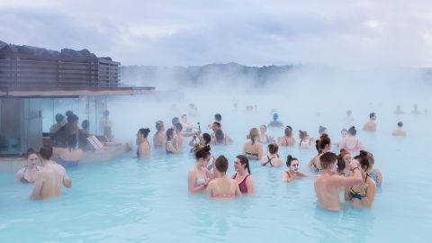 People swim in Iceland's famous Blue Lagoon and apply silica mud masks in southwest Iceland