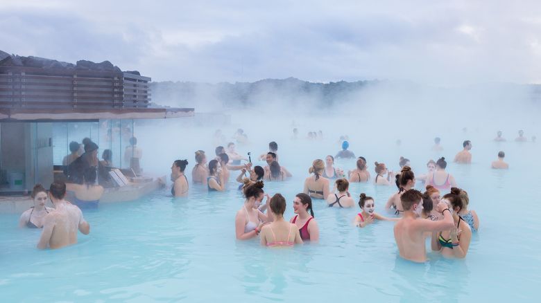 People swim in Iceland's famous Blue Lagoon and apply silica mud masks in southwest Iceland