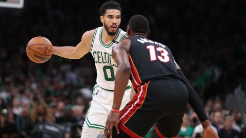 Jayson Tatum looks to move the ball defended by Bam Adebayo. 